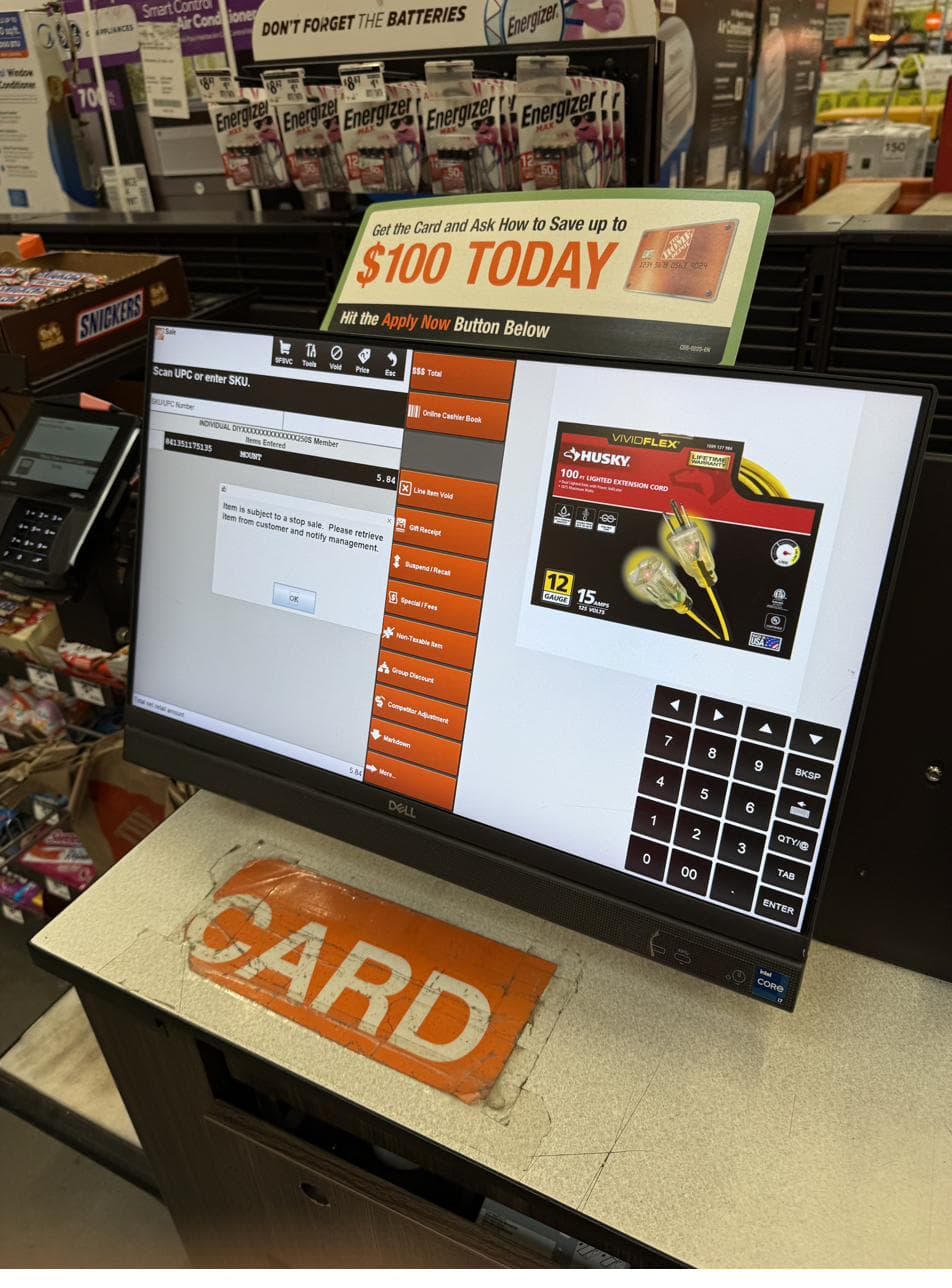 Home Depot register screen reading 'Item is subject to a stop sale' with instructions to retrieve the item