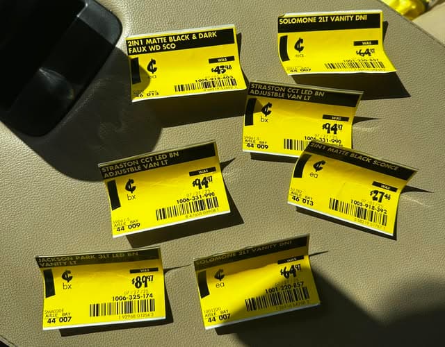Seven yellow $0.01 penny tags collected from a single Home Depot store trip